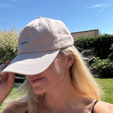 Wiild Swimwear Mahua Cap in beige color viewed from the side on model
