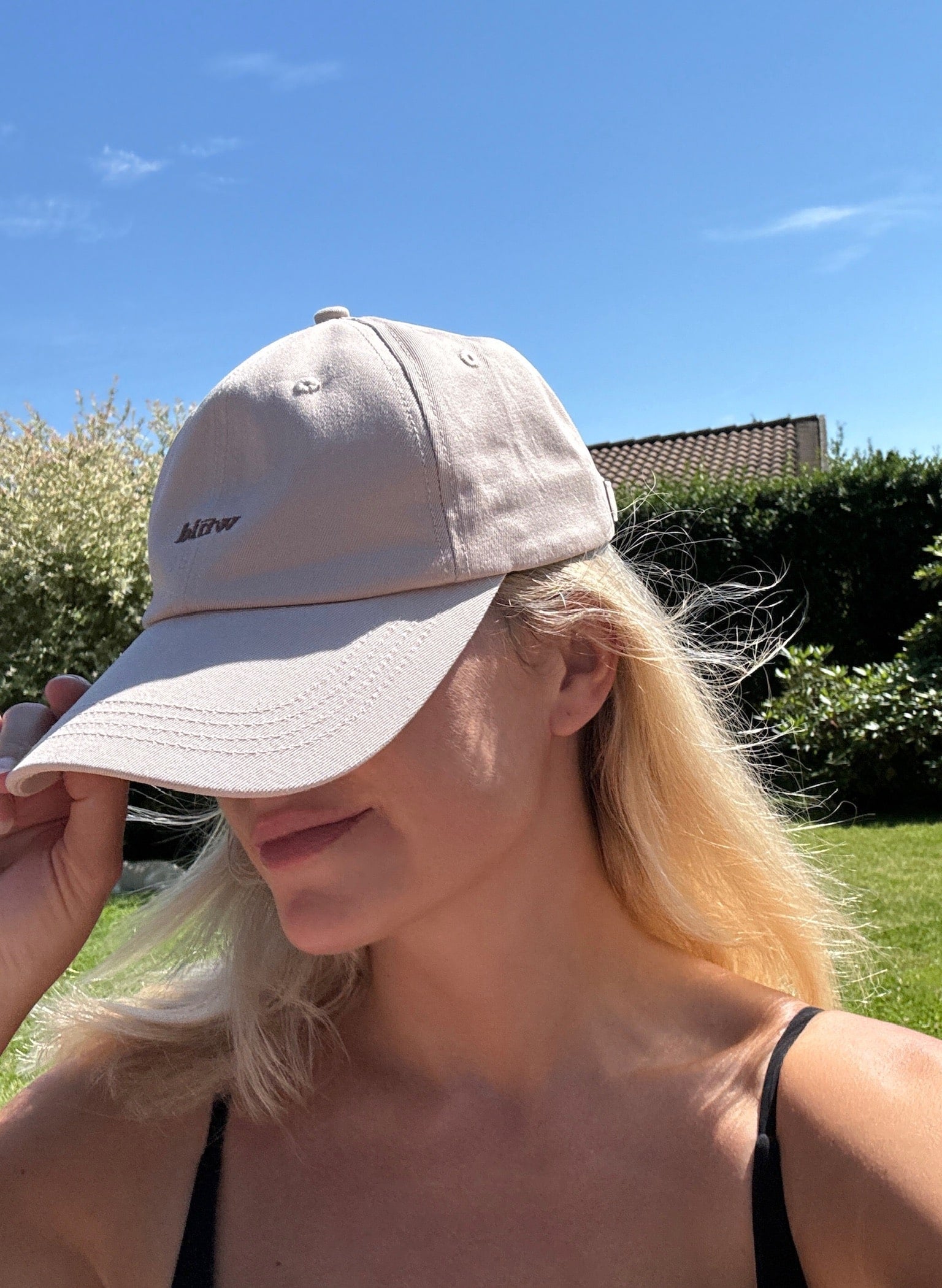 Wiild Swimwear Mahua Cap in beige color viewed from the side on model